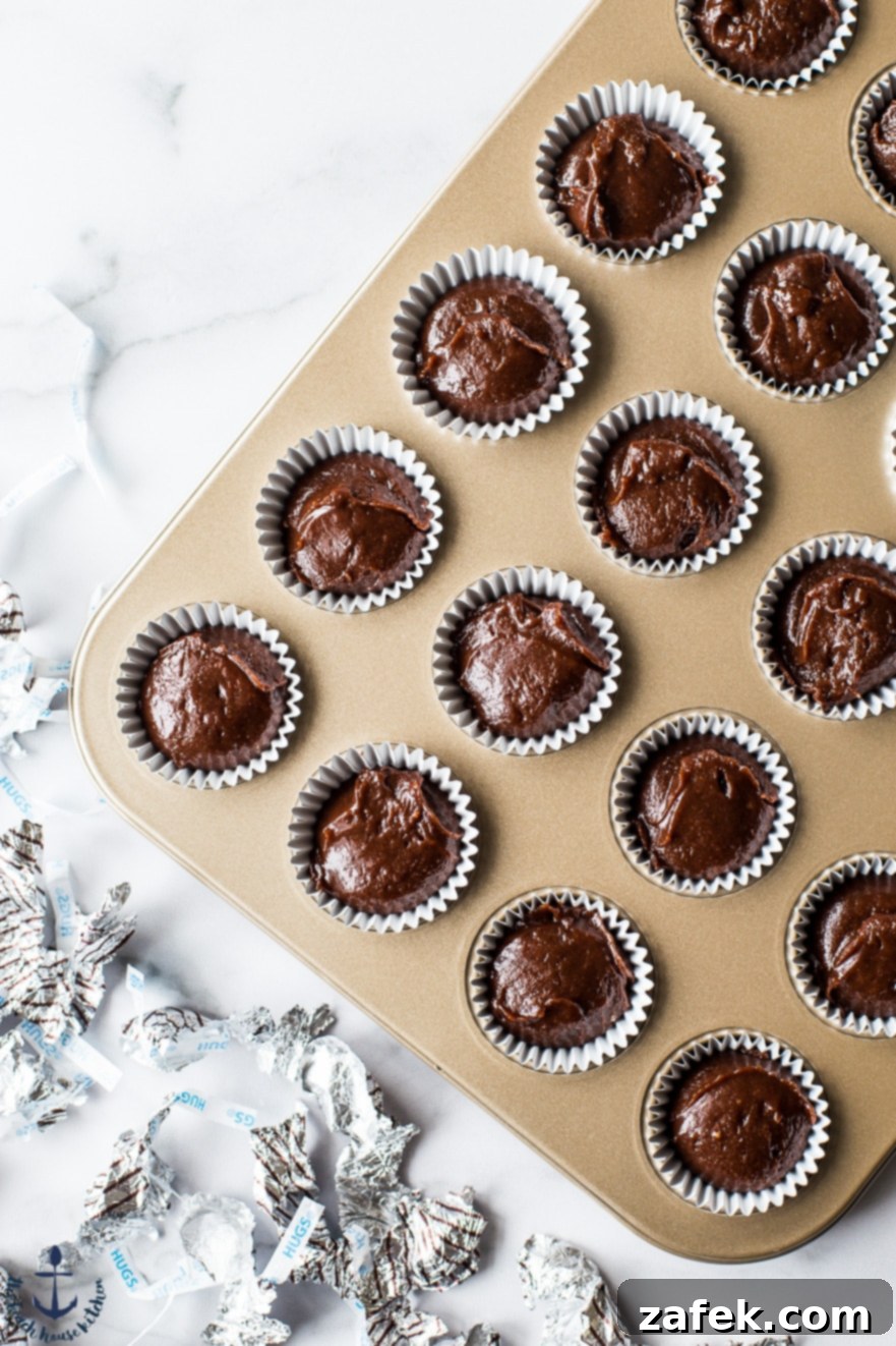 Hershey's Hug Brownie Bites Overhead photo of muffin cups filled with rich brownie batter, ready for baking.