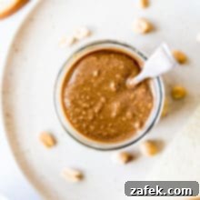 Barista Blend Peanut Butter 7 A charming close-up of homemade Cappuccino Peanut Butter in a jar, ready to be served and enjoyed.