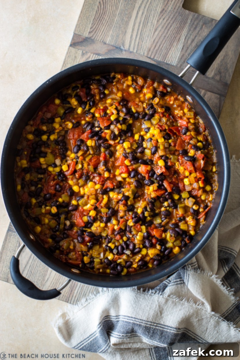 Southwestern Chicken Tortilla Bake 5 Overhead photo of a skillet with sautéing onions and garlic, forming the aromatic base for the casserole