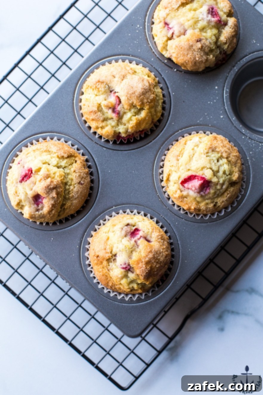Sunshine Strawberry Lemon Muffins 6 Another overhead perspective of baked strawberry lemon muffins cooling in the pan, showing their consistent golden color and soft, inviting texture.