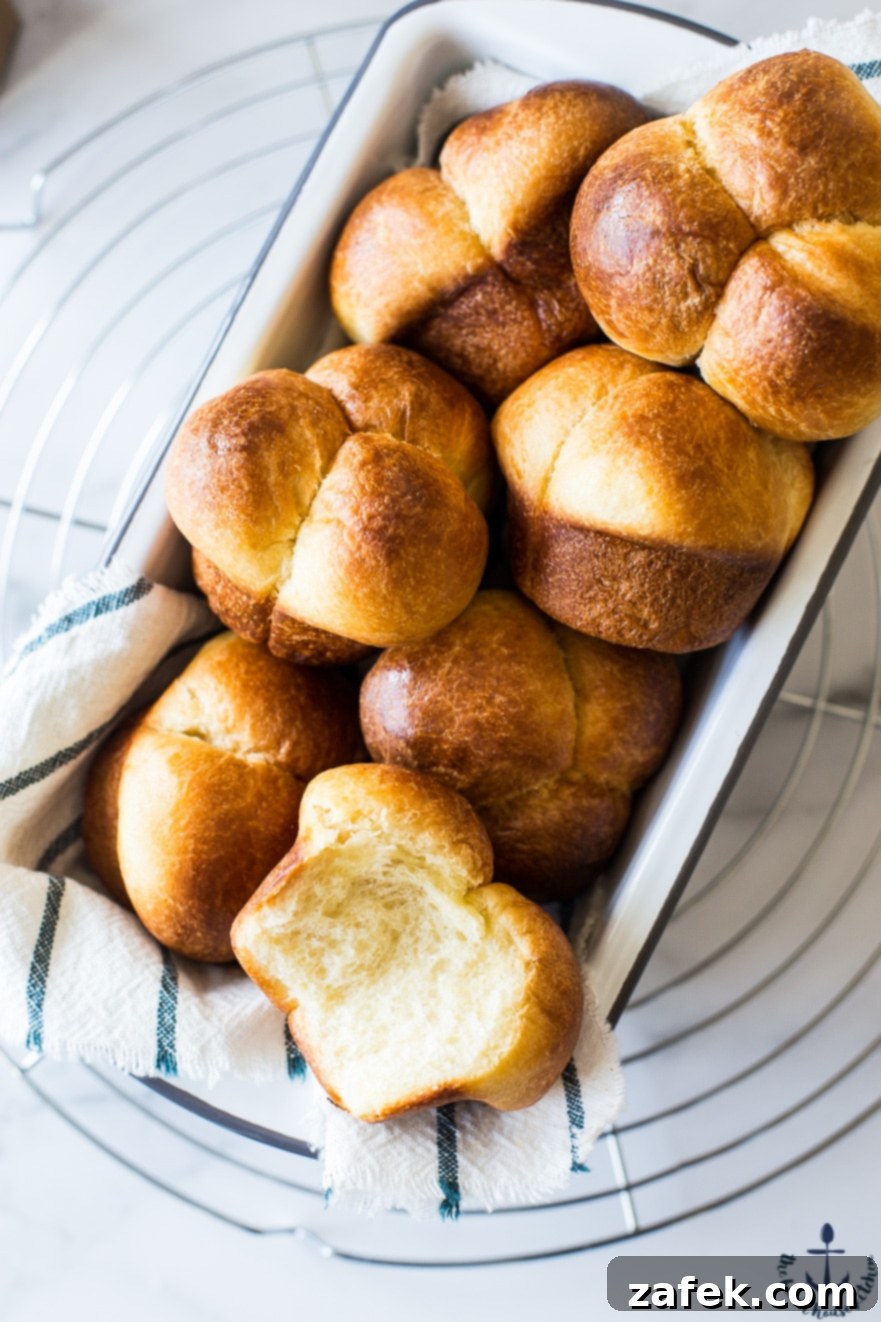 Puffy Brioche Buns 3 Close-up of perfectly baked Bubble-Top Brioche Rolls in a loaf pan, showcasing their soft, bubbly tops.