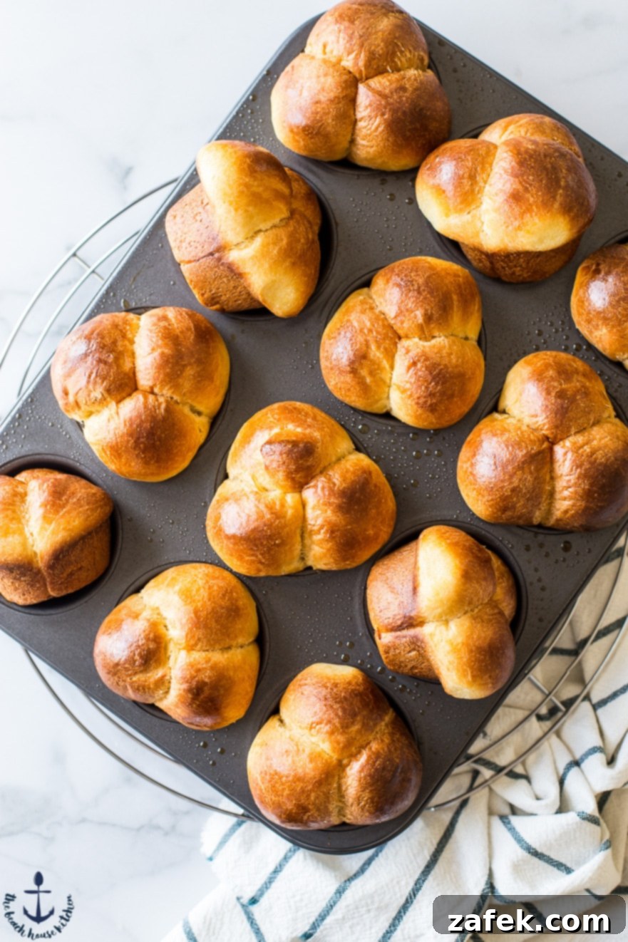 Puffy Brioche Buns 4 Freshly baked Bubble-Top Brioche Rolls arranged in a muffin pan, highlighting their individual, fluffy sections.