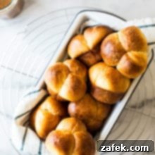 Puffy Brioche Buns 9 A freshly baked Bubble-Top Brioche Roll with a glossy, golden crust, ready to be enjoyed.