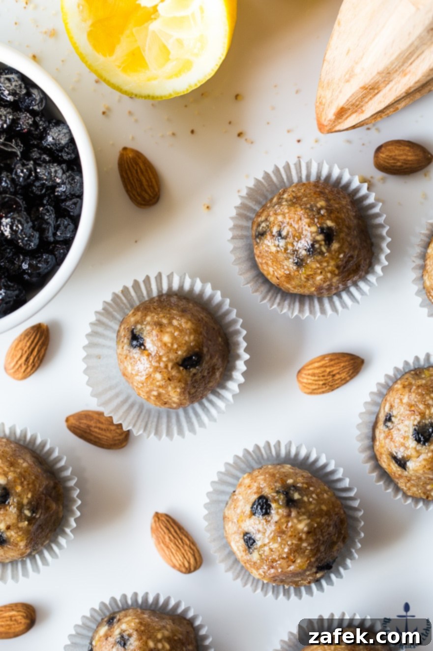 Overhead view of blueberry lemon breakfast bites scattered on a light surface, emphasizing their grab-and-go appeal and appealing texture.