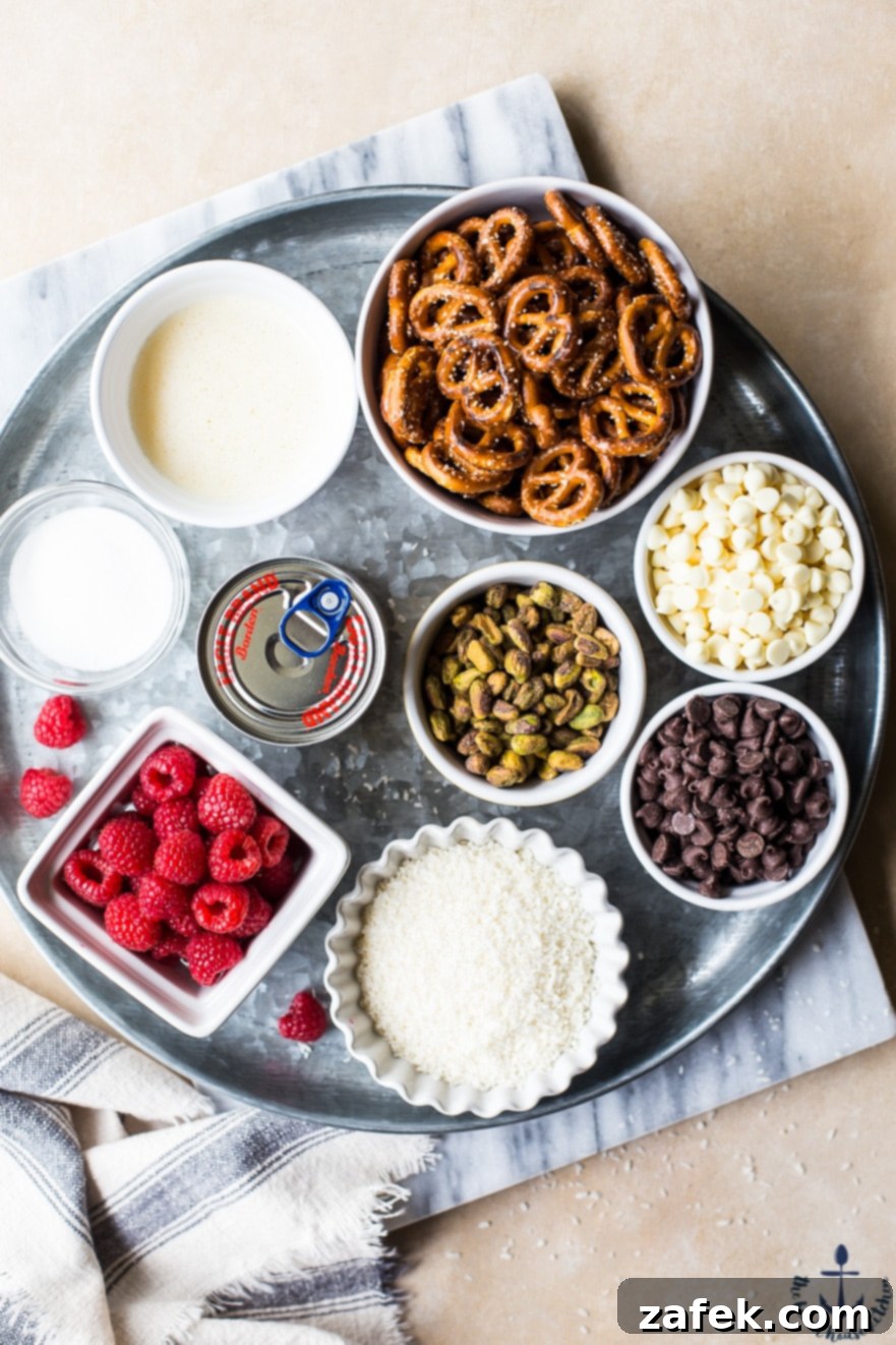 Overhead shot showcasing all the fresh, high-quality ingredients for Raspberry Pistachio Magic Bars neatly arranged on a silver tray, ready for baking.
