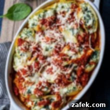 Overhead photo of easy spinach stuffed shells in a white dish on a wooden board