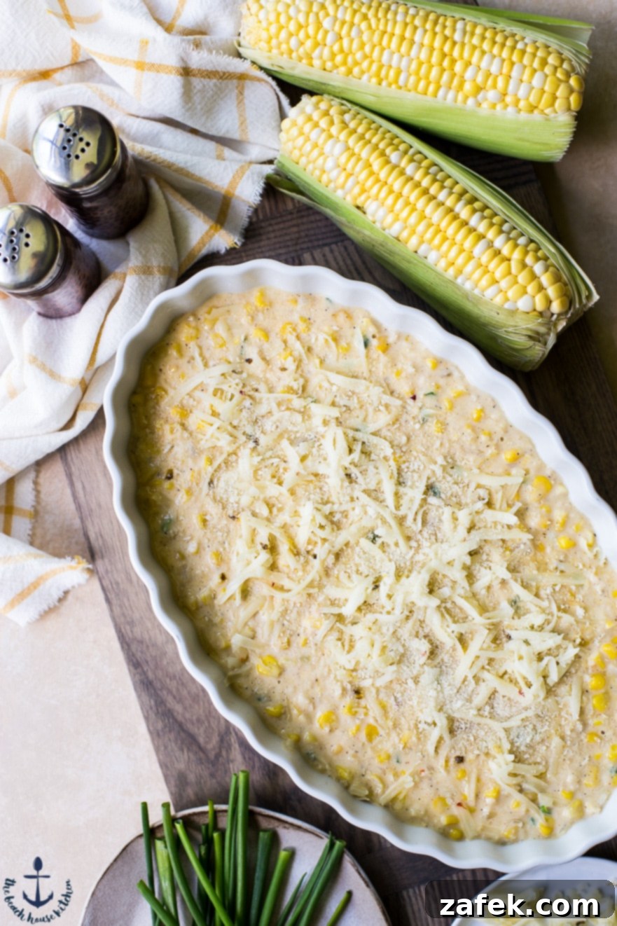 Overhead photo of Cheesy Corn Casserole with a few ears of corn