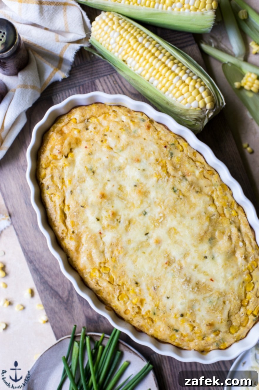 Overhead photo of Cheesy Corn Casserole with a few ears of corn