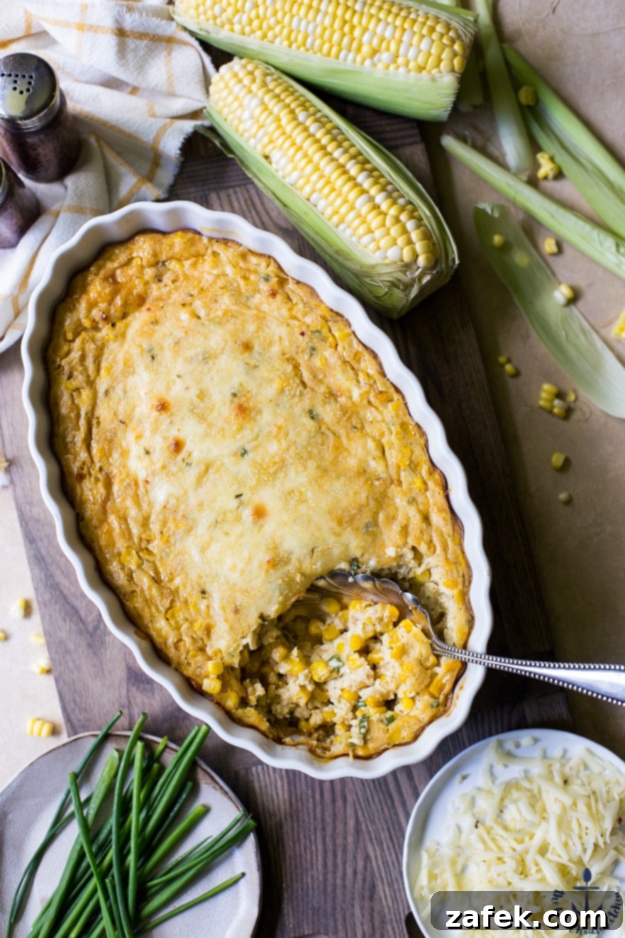 Overhead photo of Cheesy Corn Casserole with a few ears of corn