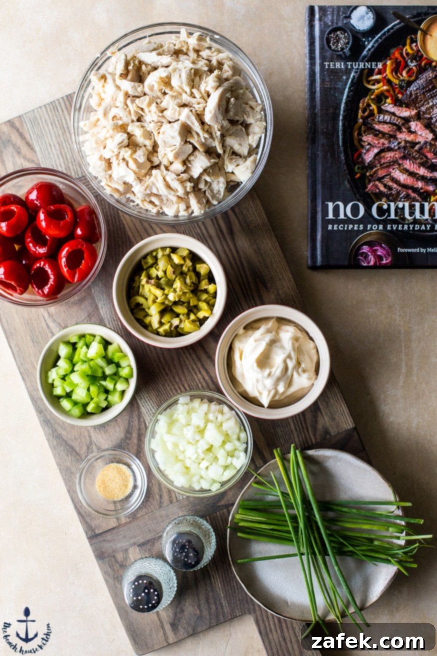 Mediterranean Peppadew and Olive Chicken Salad 5 Photo of ingredients for Chicken salad in bowls on wooden board