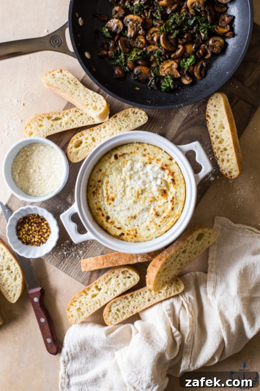 Savory Ricotta Custard with Sautéed Mushroom Shallot and Kale 4 Overhead photo of baked ricotta in a white crock surrounded by bread slices, ready for a gathering