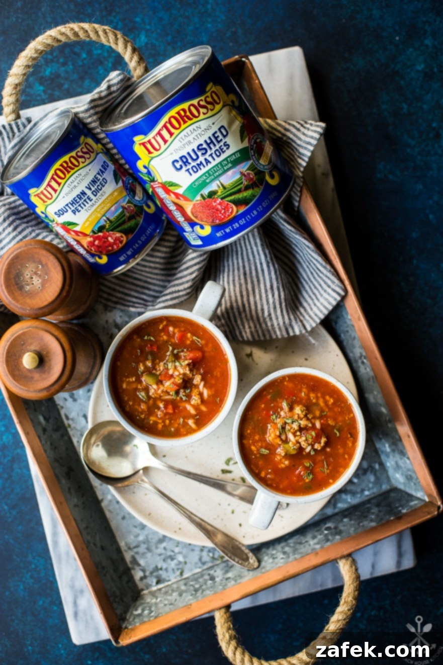 Overhead photo of mugs of stuffed pepper soup with cans of tomatoes