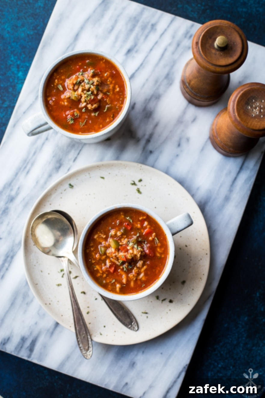 Overhead photo of mugs of stuffed pepper soup on a marble board