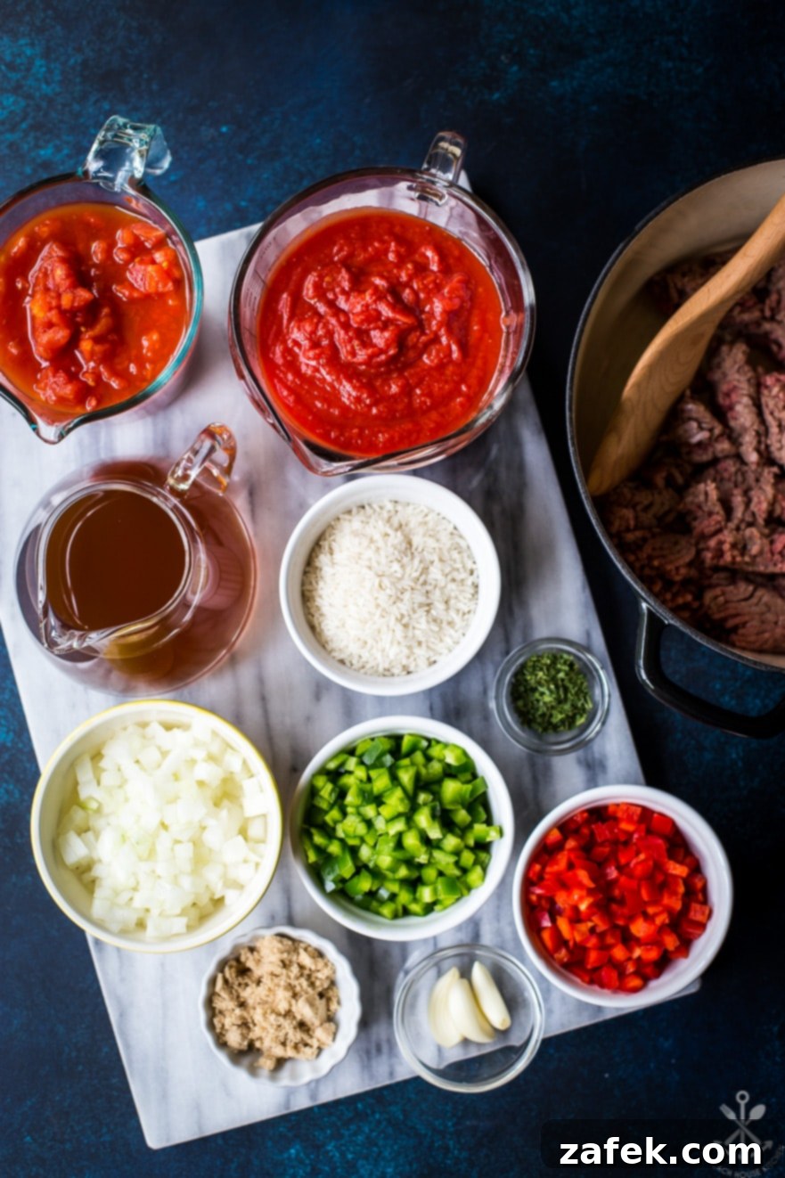 Overhead photo of ingredients for stuffed pepper soup in bowls on marble board