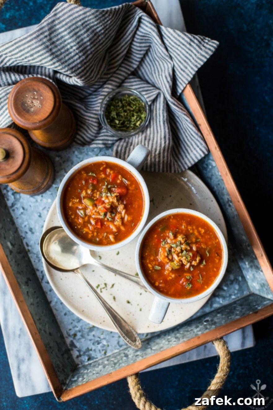 Overhead photo of mugs of stuffed pepper soup on a silver tray