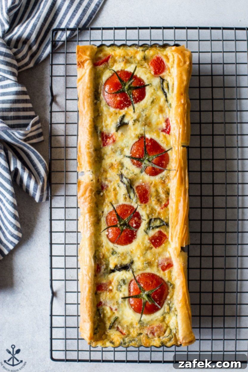 A close-up of fresh basil leaves and ripe tomatoes, key ingredients for the tart.