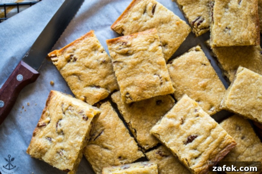 Overhead photo of beautifully cut slices of pecan bourbon blondies, ready for serving.