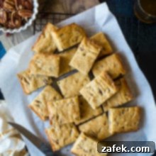 Overhead photo of a 9x13 pan filled with golden-brown pecan bourbon blondies.