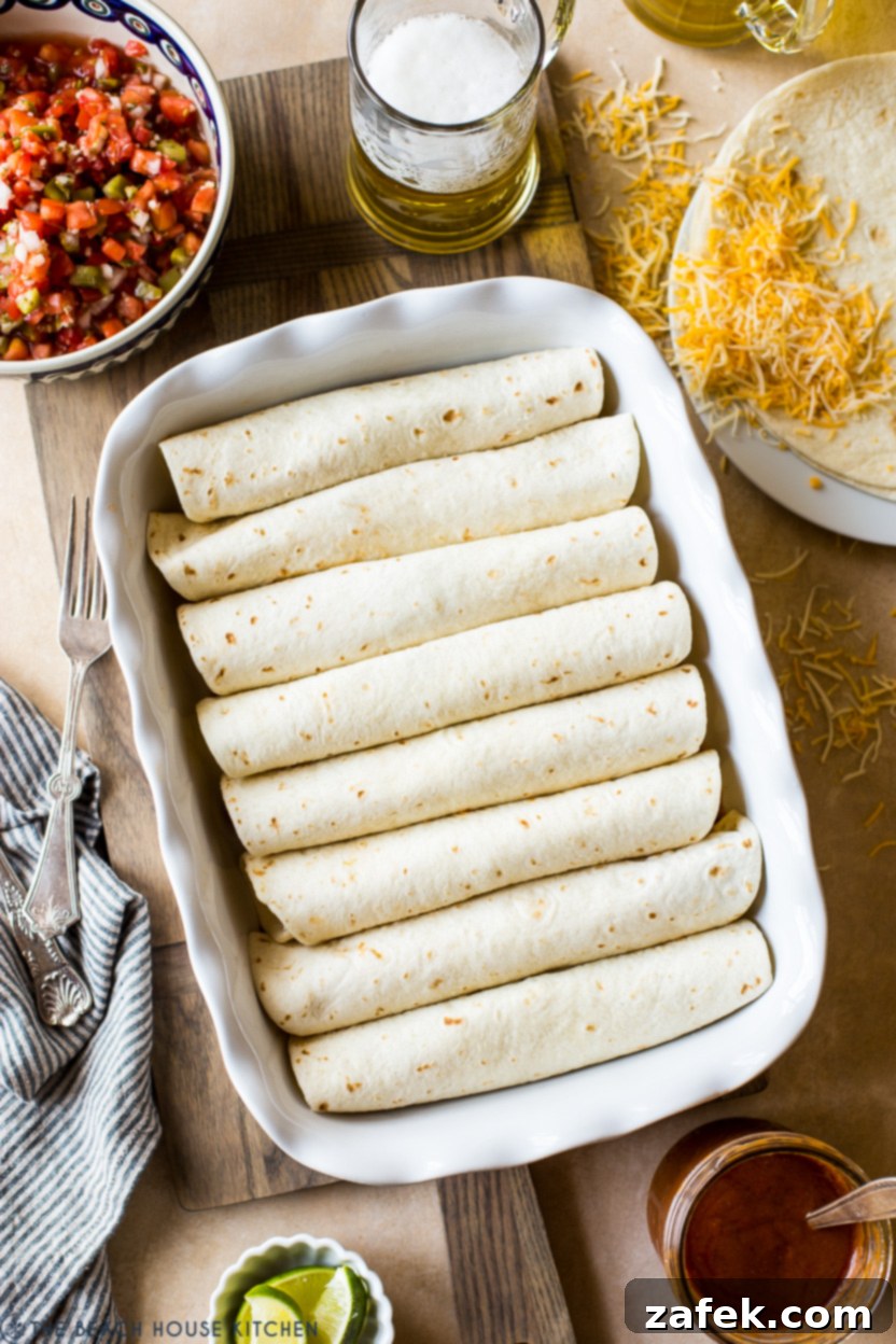 Effortless Homemade Beef Enchiladas 6 Overhead photo of a pan of pre-baked enchiladas