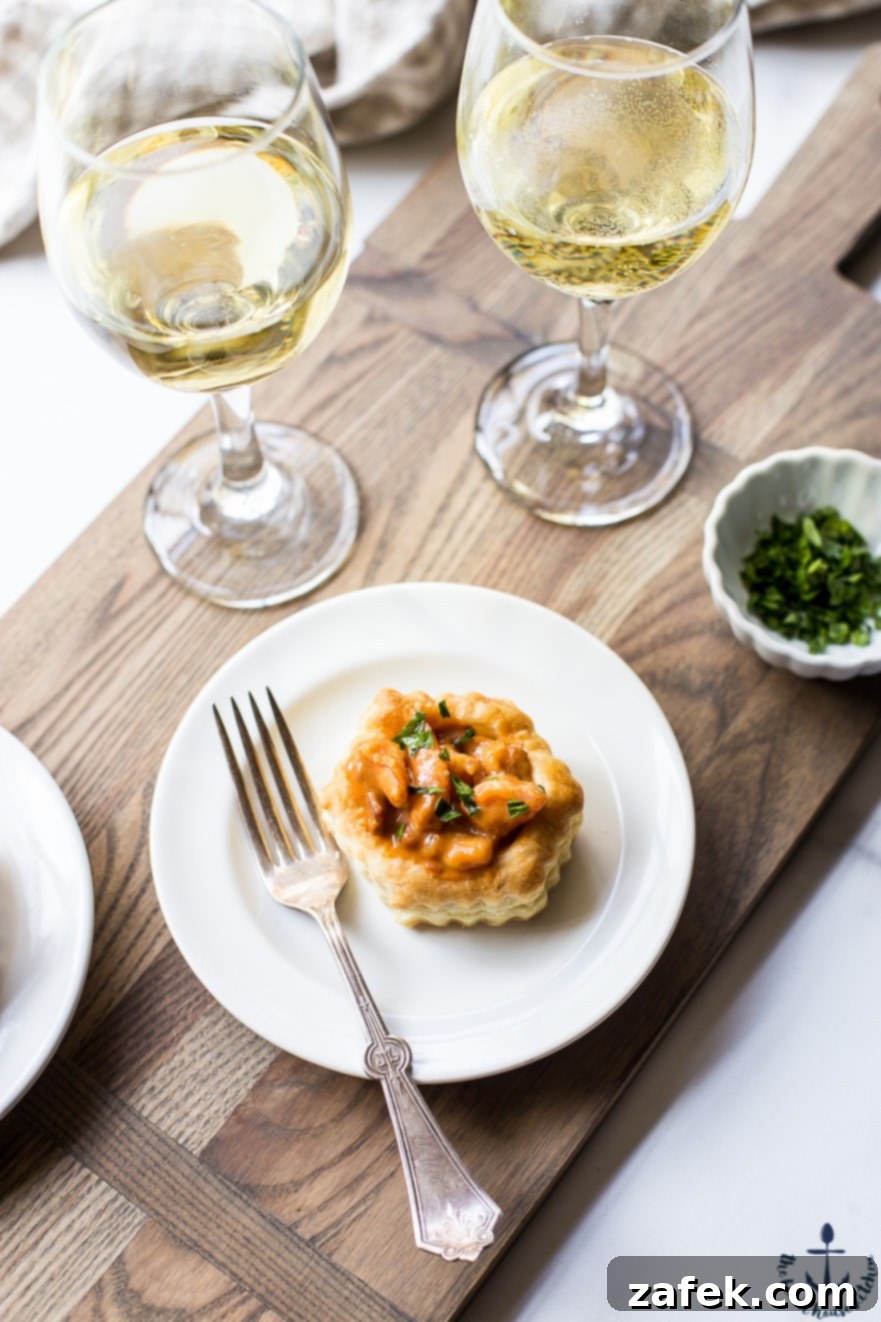 Louisiana Etouffee Shrimp Puffs 3 Overhead photo of a shrimp etouffee vol au vent on a white plate with a fork