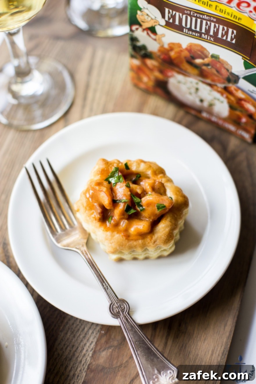 Louisiana Etouffee Shrimp Puffs 10 Photo of shrimp etouffee vol au vent on a white plate with a fork