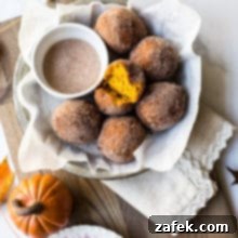 Overhead photo of cinnamon sugared pumpkin fritters in a dish