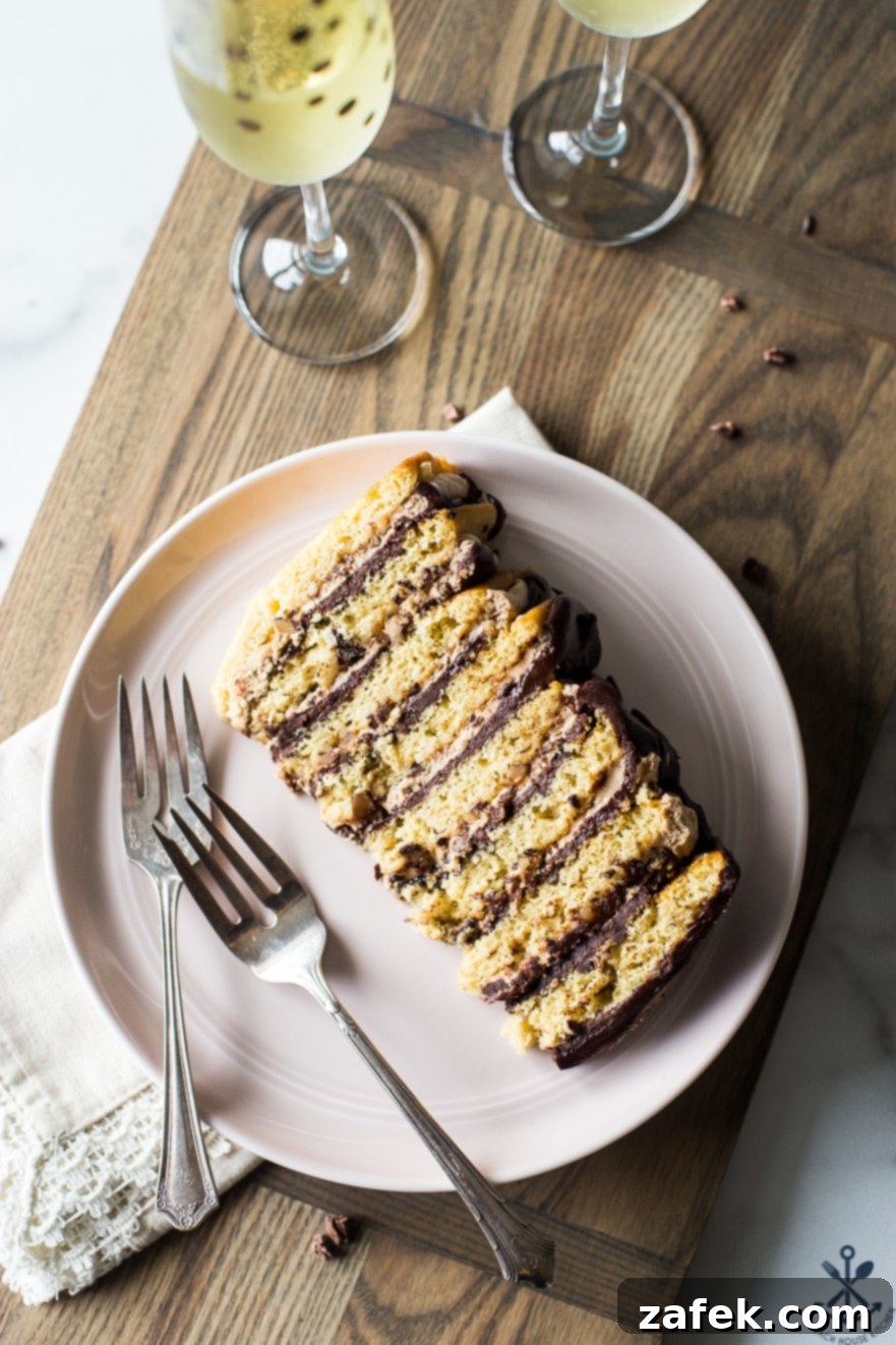 Armenian Honey Cake 9 A delectable slice of 8-layer Armenian-style cake, presented on a charming pink plate with two forks, inviting tasters to dig in