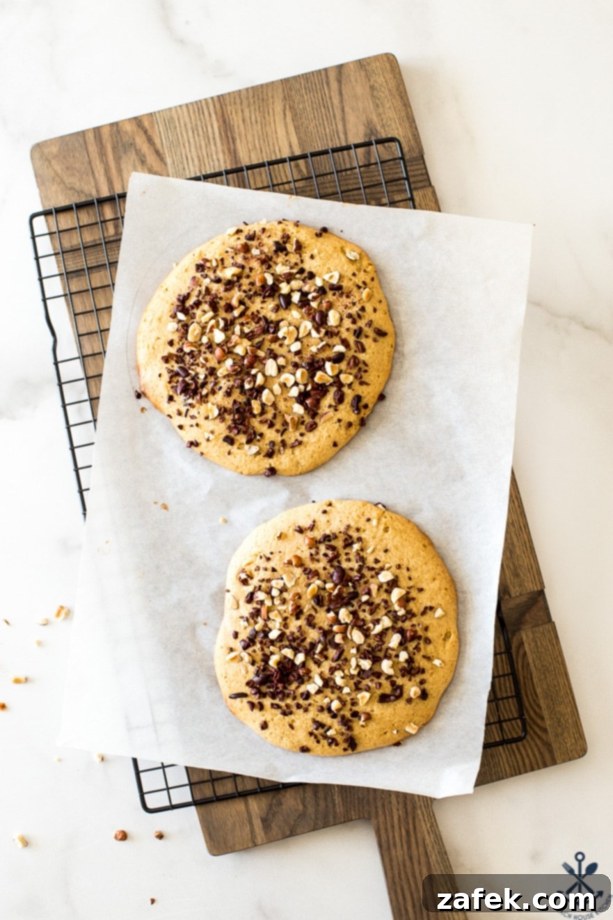 Armenian Honey Cake 10 Two golden-brown layers of Armenian cake cooling on a wire rack, perfectly baked and ready for assembly