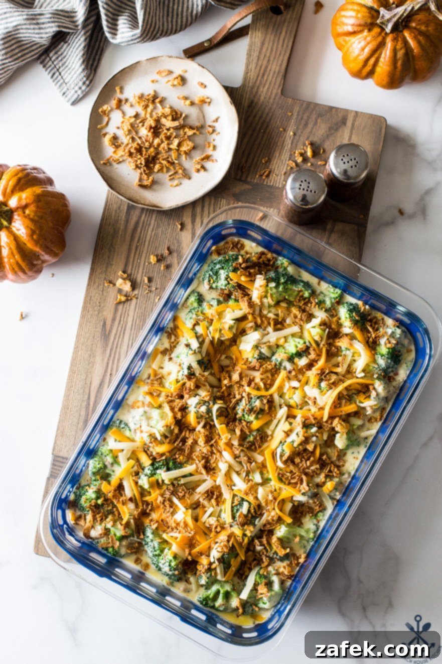 Effortless Festive Broccoli Bake 11 Overhead photo of prebaked easy holiday broccoli casserole on a wooden board