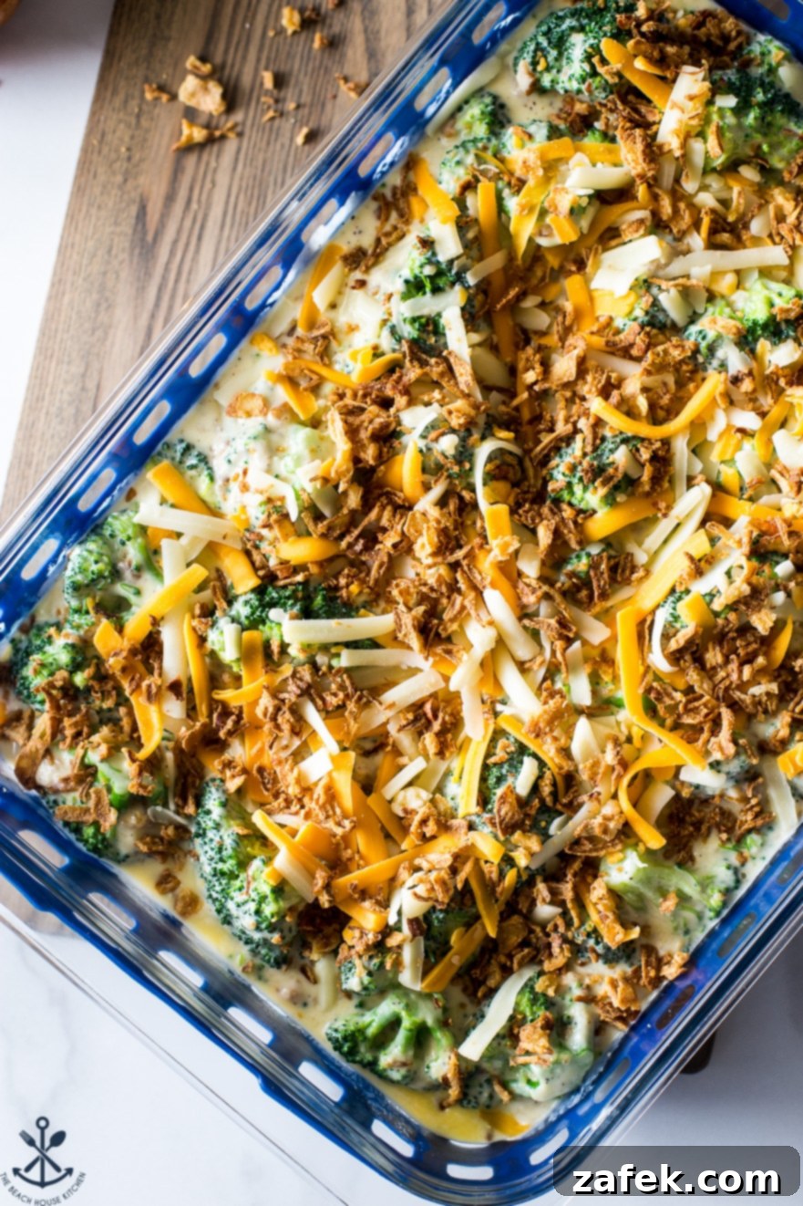 Effortless Festive Broccoli Bake 5 Up close overhead photo of prebaked easy holiday broccoli casserole on a wooden board
