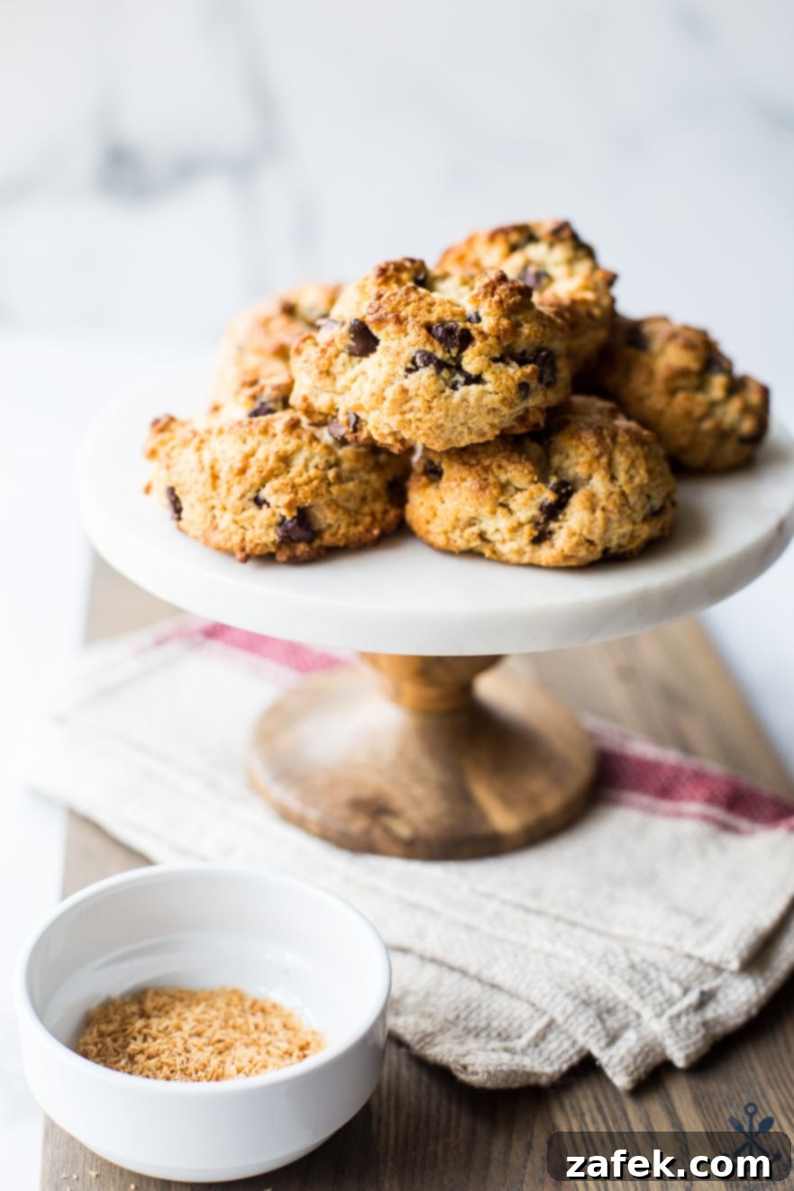 Golden Toasted Coconut Chocolate Chip Scones 2 Cake stand topped with golden-brown chocolate chip toasted coconut scones, inviting and delicious