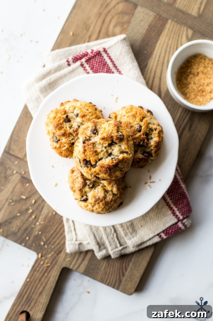 Golden Toasted Coconut Chocolate Chip Scones 5 Overhead view of chocolate chip toasted coconut scones arranged beautifully on a white cake stand