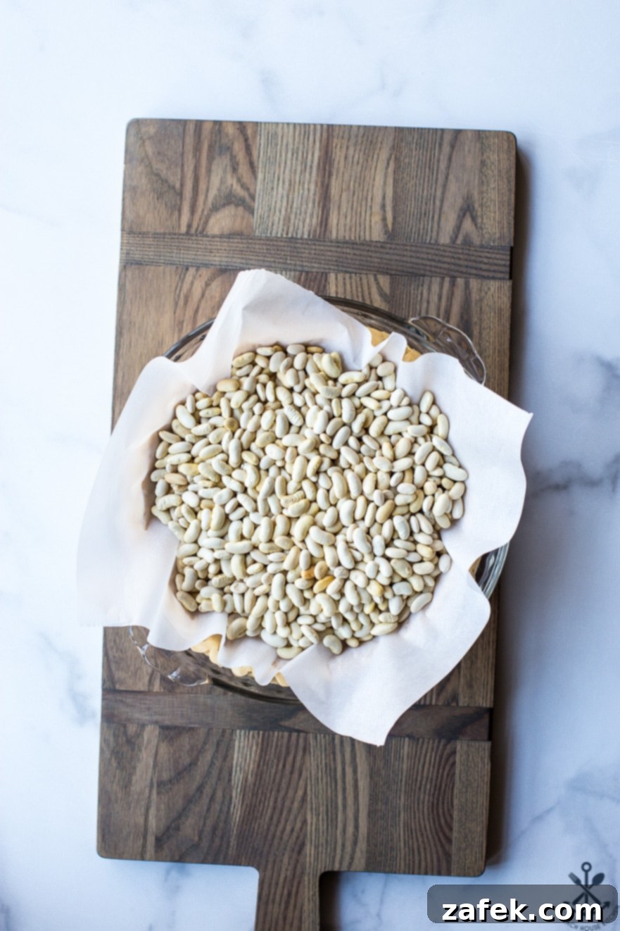 Ingredients for Quiche Lorraine laid out on a kitchen counter: bacon, onions, eggs, cream, and a pie crust