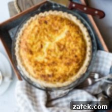 Overhead photo of quiche lorraine in a pie plate on a silver tray