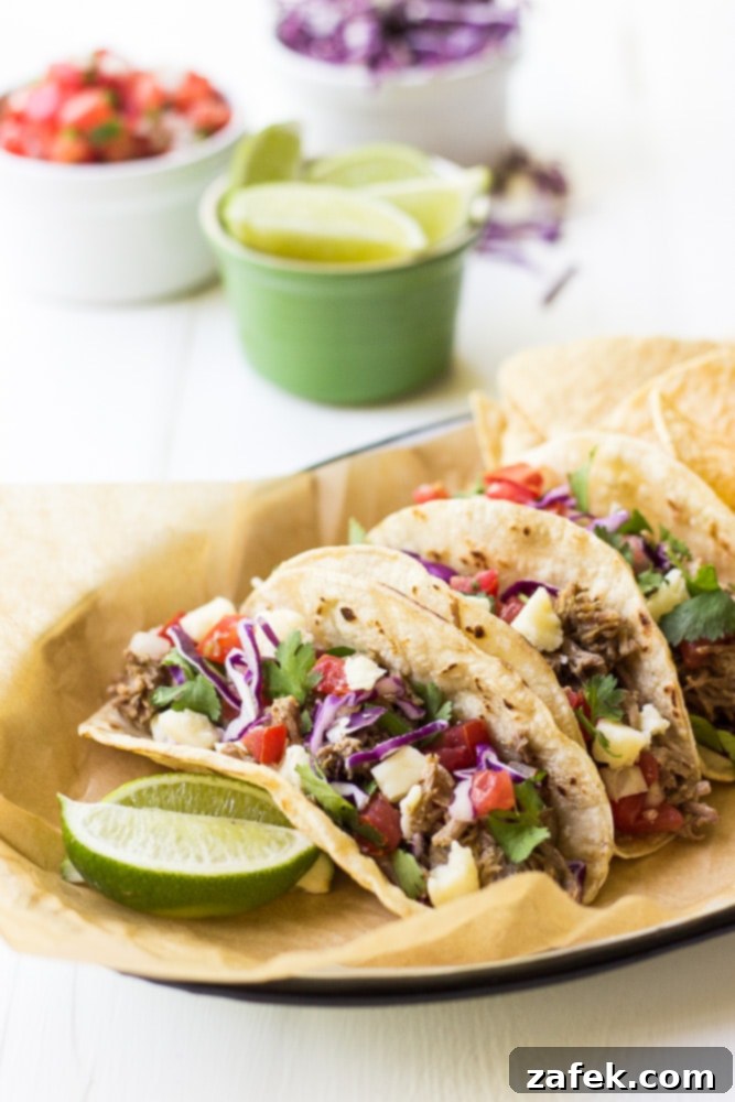 A large skillet filled with shredded, crispy pork carnitas, ready to be served.