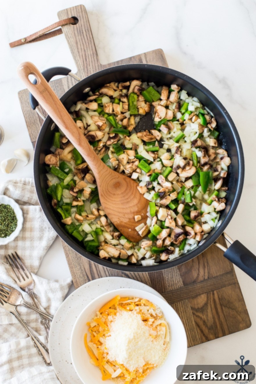 Creamy Tuna Noodle Delight 4 Ingredients for tuna noodle casserole, including chopped mushrooms, peppers, onions, and canned tuna.