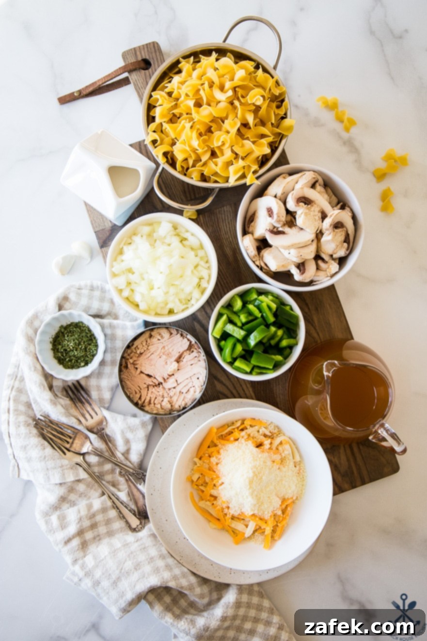 Creamy Tuna Noodle Delight 5 A serving spoon lifting a portion of tuna noodle casserole, showing the creamy texture and cheese.