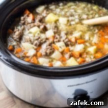 Bratwurst Potato Soup in a slow cooker, a close-up of the delicious ingredients