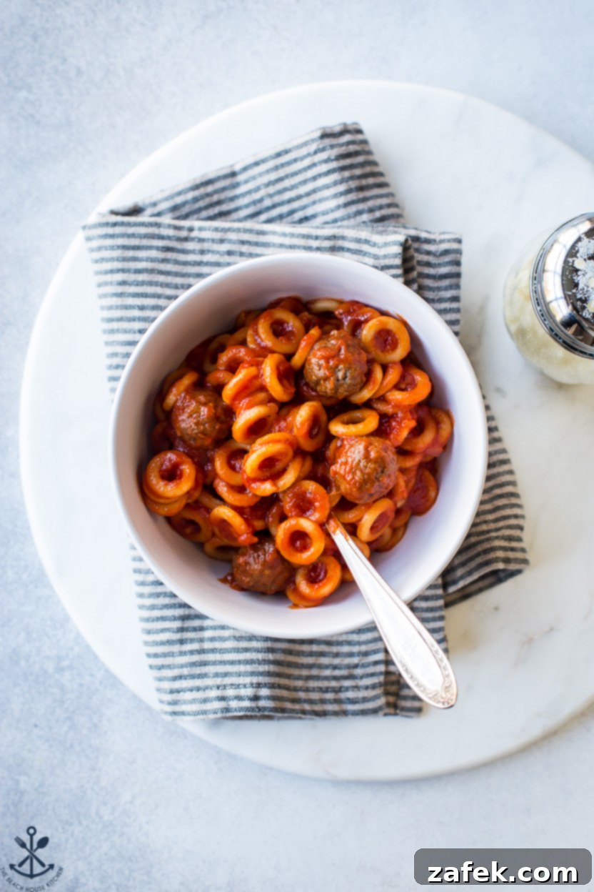 Up close overhead photo of a bowl of homemade SpaghettiO's with meatballs