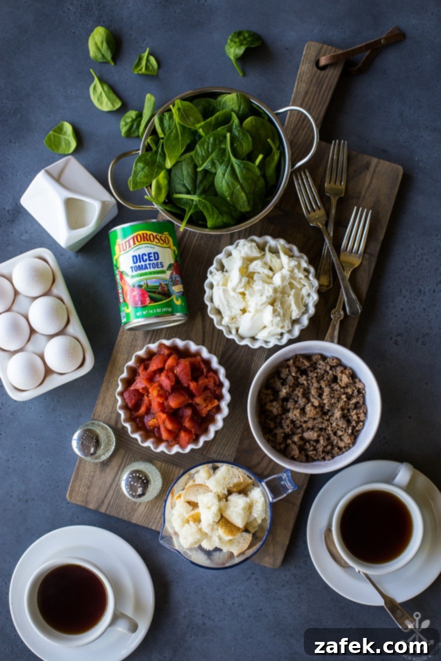 Overhead flat lay of all the fresh ingredients for the egg cup recipe – cooked sausage, diced Tuttorosso tomatoes, fresh spinach, mozzarella cubes, large eggs, and cubed French bread – neatly arranged in bowls on a rustic wooden tray, ready for preparation
