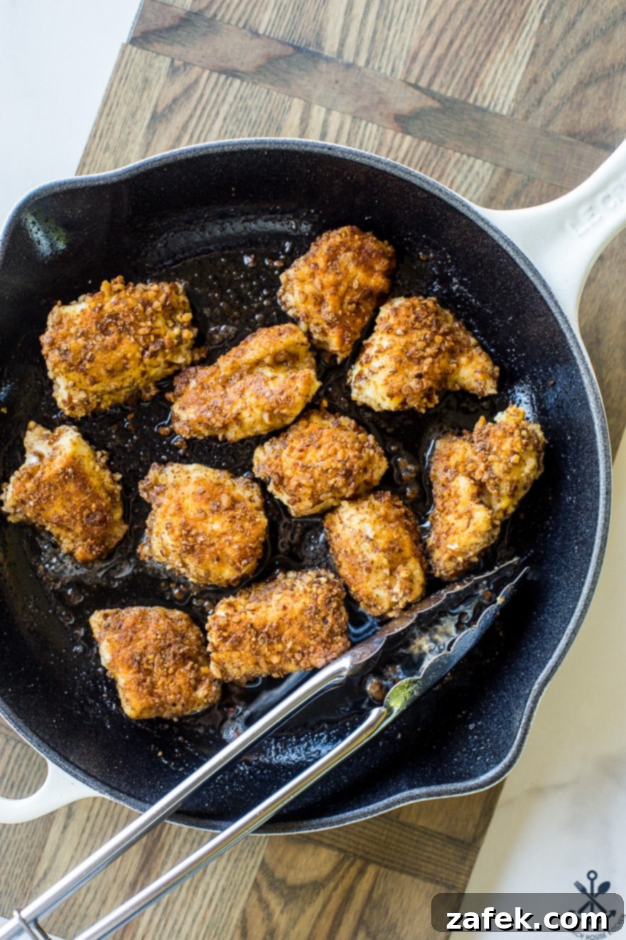 Crispy Pretzel Chicken Bites with Signature Mustard Sauce 3 Overhead photo of pretzel crusted chicken nuggets in a skillet