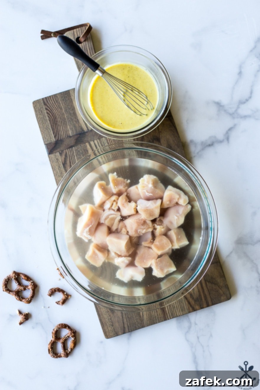 Crispy Pretzel Chicken Bites with Signature Mustard Sauce 6 Overhead photo of chicken cubes in a water brine