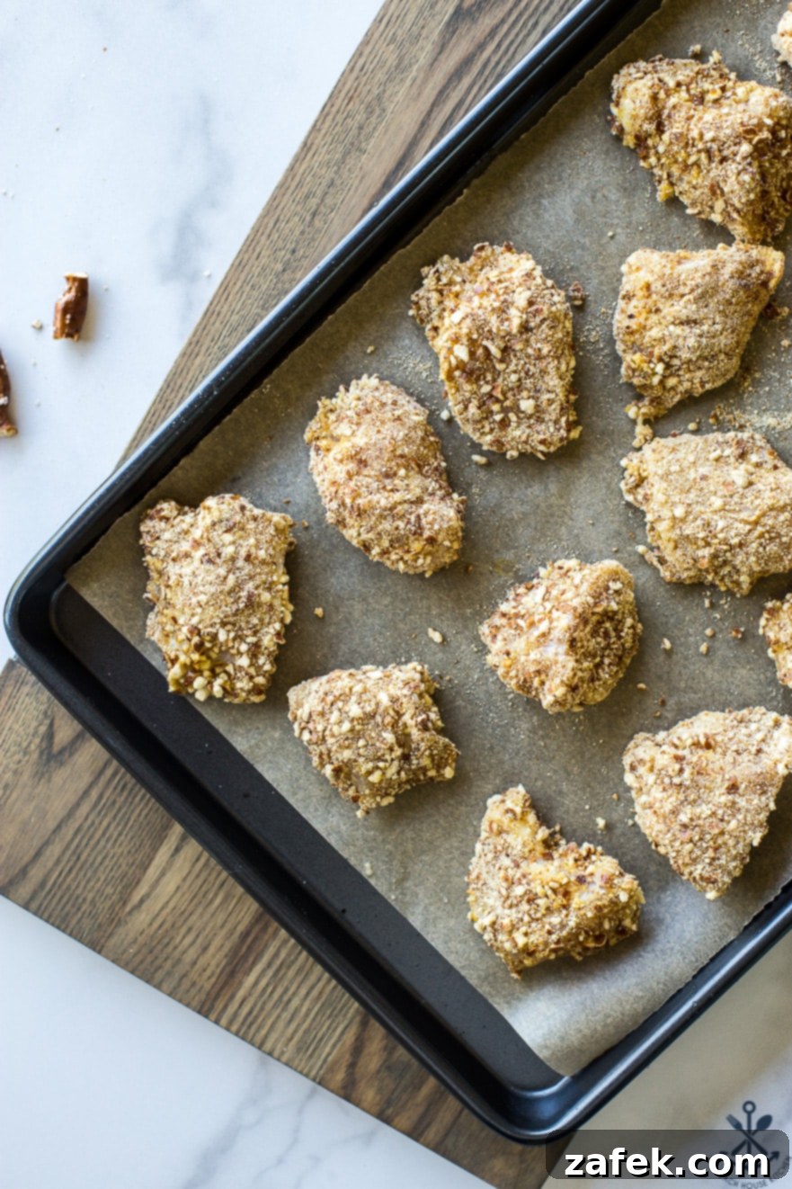 Crispy Pretzel Chicken Bites with Signature Mustard Sauce 7 Up close overhead photo of pre-cooked pretzel coated chicken nuggets