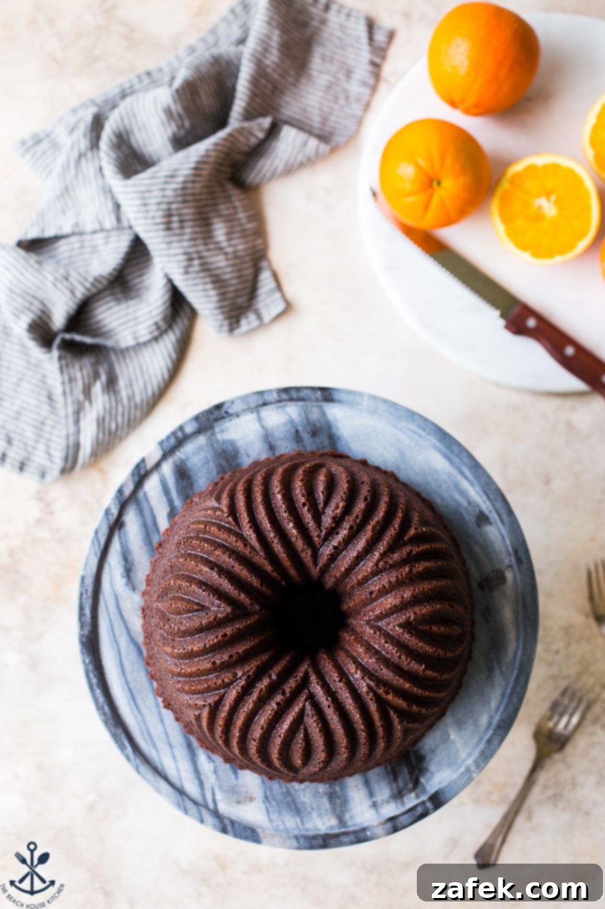 Zesty Chocolate Orange Bundt 6 An overhead shot showcasing the intricate design of the Chocolate Orange Bundt Cake, served on a marble cake plate.