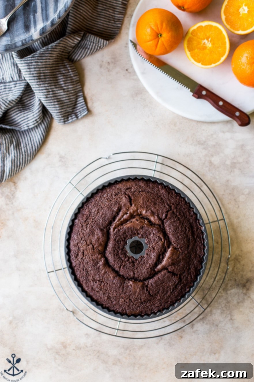 Zesty Chocolate Orange Bundt 8 An overhead photo of a baked chocolate orange bundt cake, perfectly golden, in the pan on a wire rack.