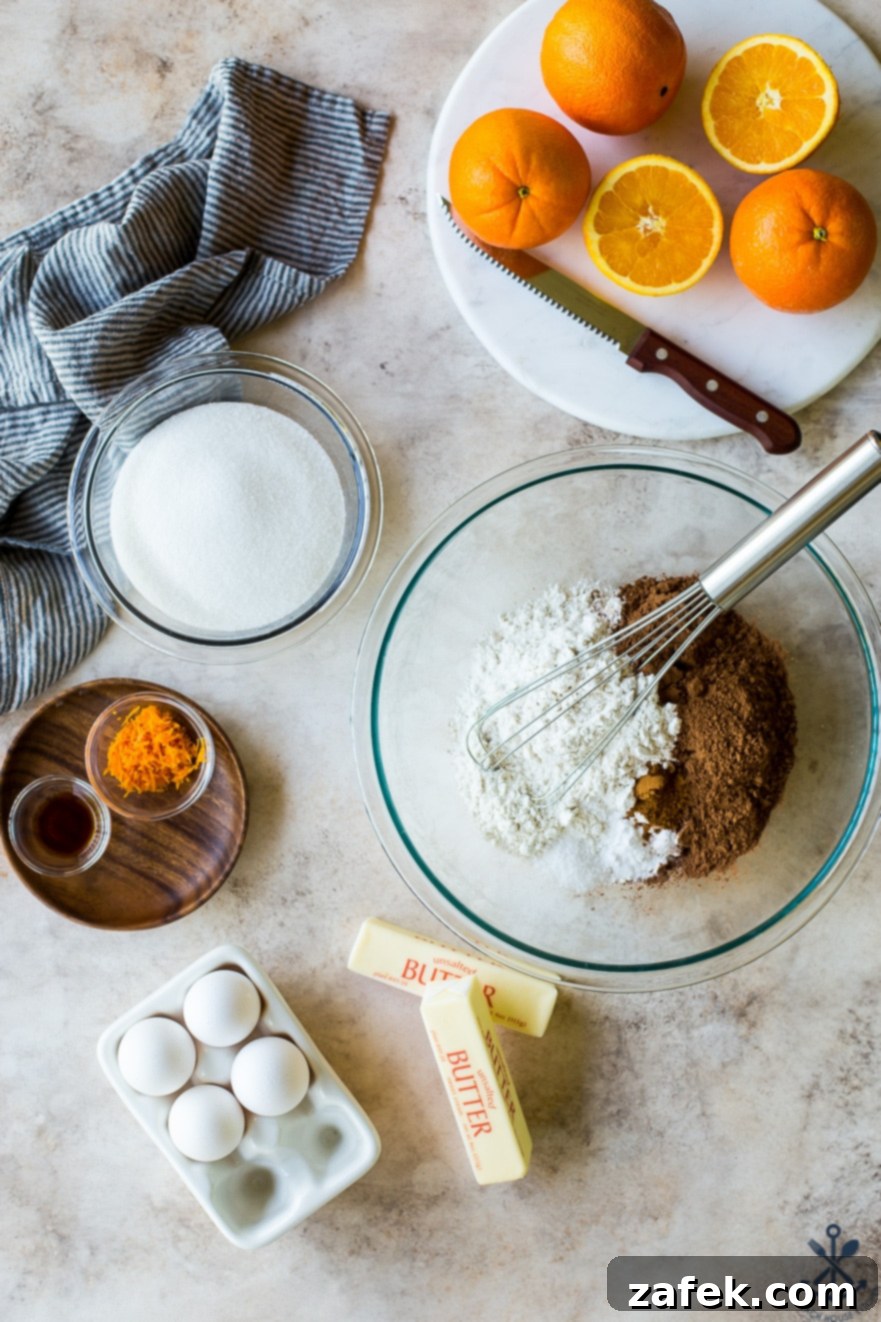 Zesty Chocolate Orange Bundt 9 An overhead photo of the dry and wet ingredients for a chocolate orange bundt cake, neatly arranged in bowls.