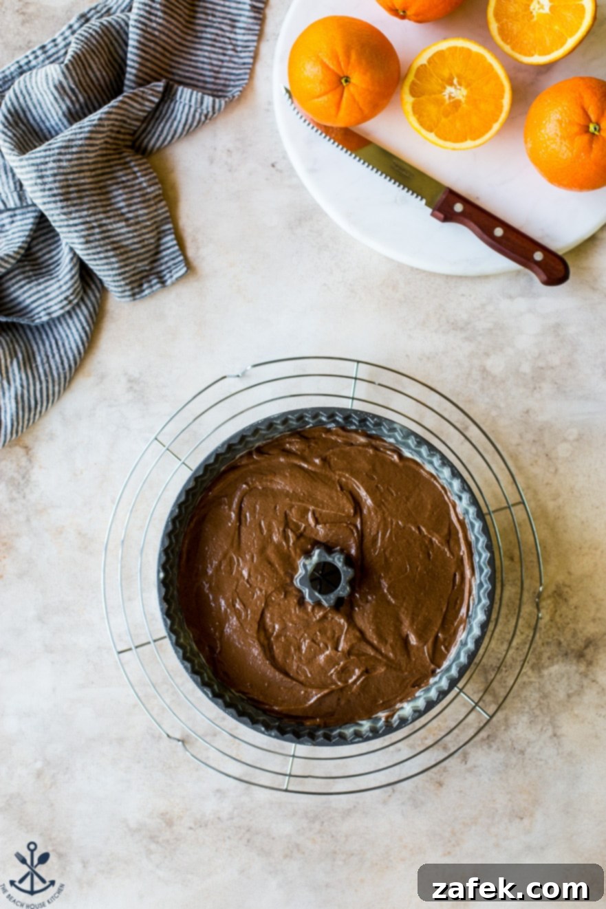 Zesty Chocolate Orange Bundt 10 Overhead photo of a pre-baked chocolate orange bundt cake batter filling the bundt pan, ready for the oven.