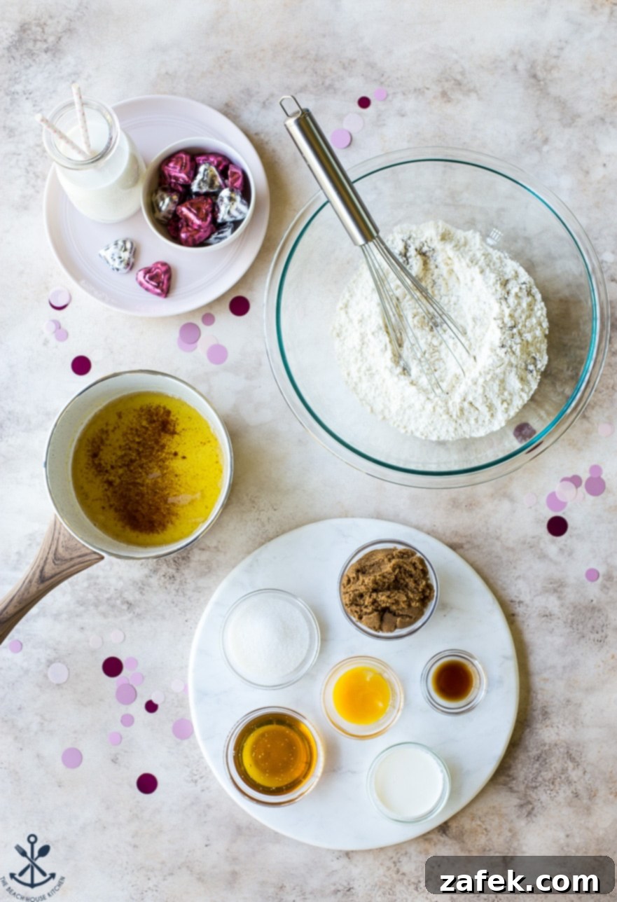 Brown Butter Honey Cardamom Delights 7 An overhead view of various ingredients for Brown Butter Honey Cardamom Cookies, neatly arranged in bowls on a wooden surface, including flour, butter, spices, and sugars, ready for baking.