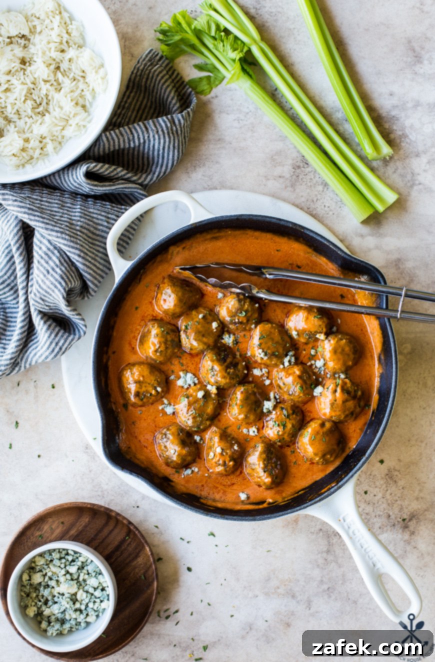Overhead photo of Buffalo Turkey Meatballs in a white skillet, ready to serve.