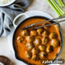 Overhead photo of buffalo turkey meatballs in a white skillet